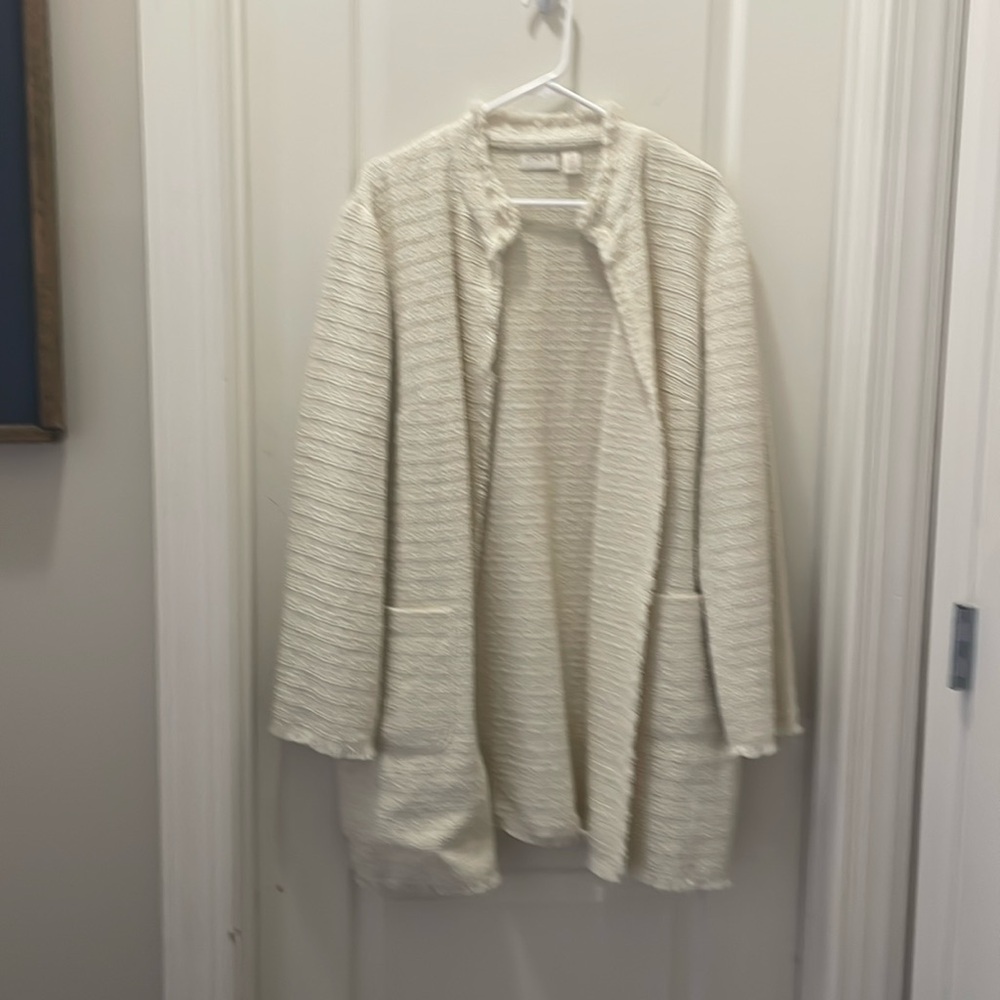 Chicos textured jacket with sheered hems on sleeves, bottom and neck of jacket.